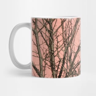 Bare tree against a pink wall Mug